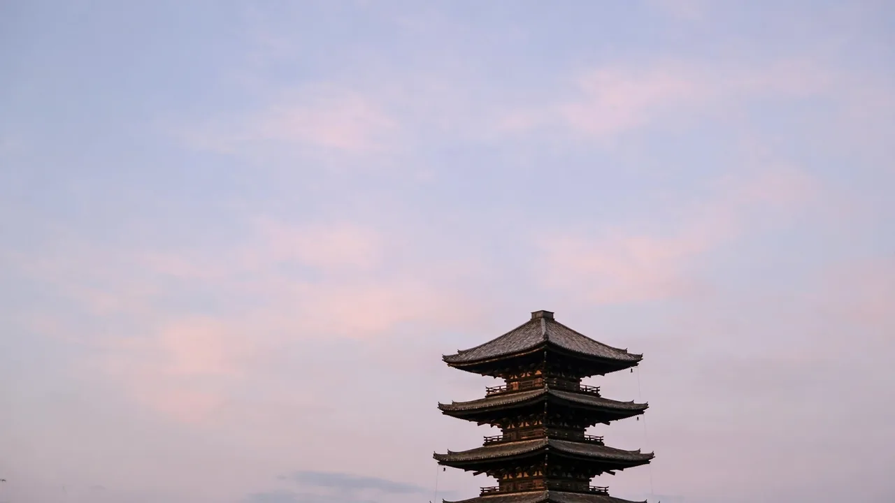 Tourists at Kiyomizu-dera temple in Kyoto overlooking the city at sunset