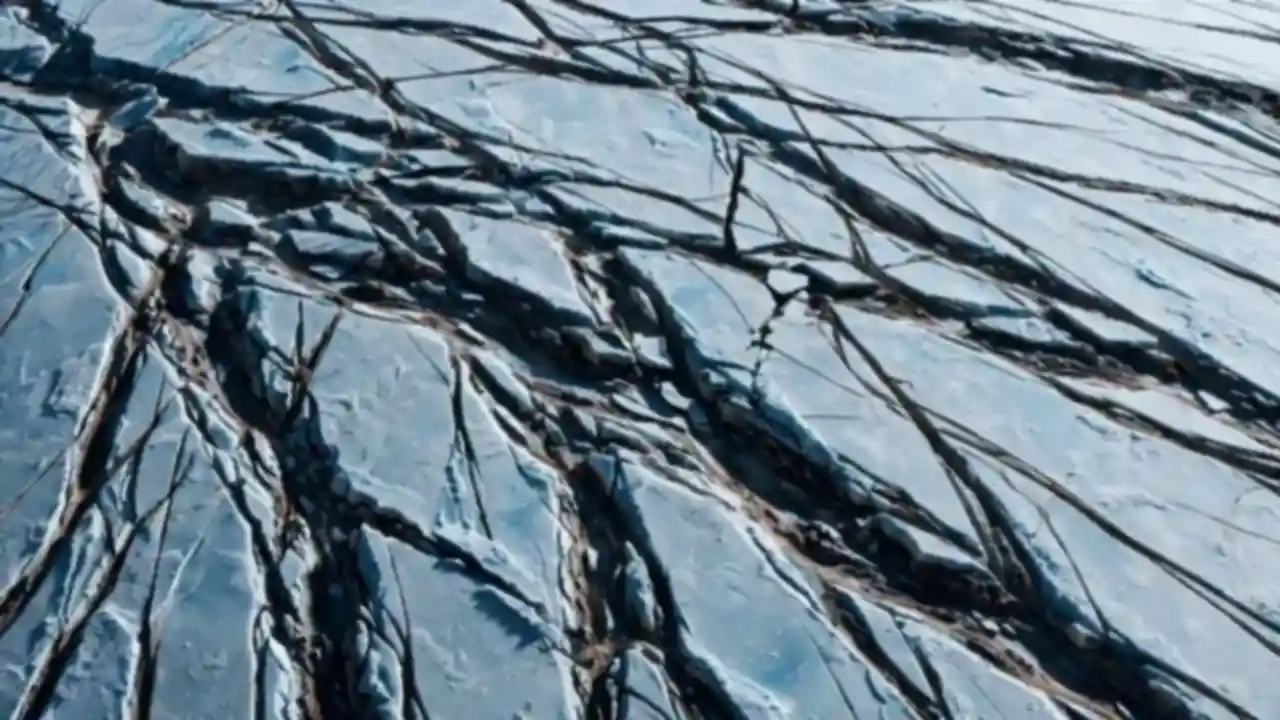 Close-up of Europa's cracked icy surface showing dark lines crossing pale blue-white ice